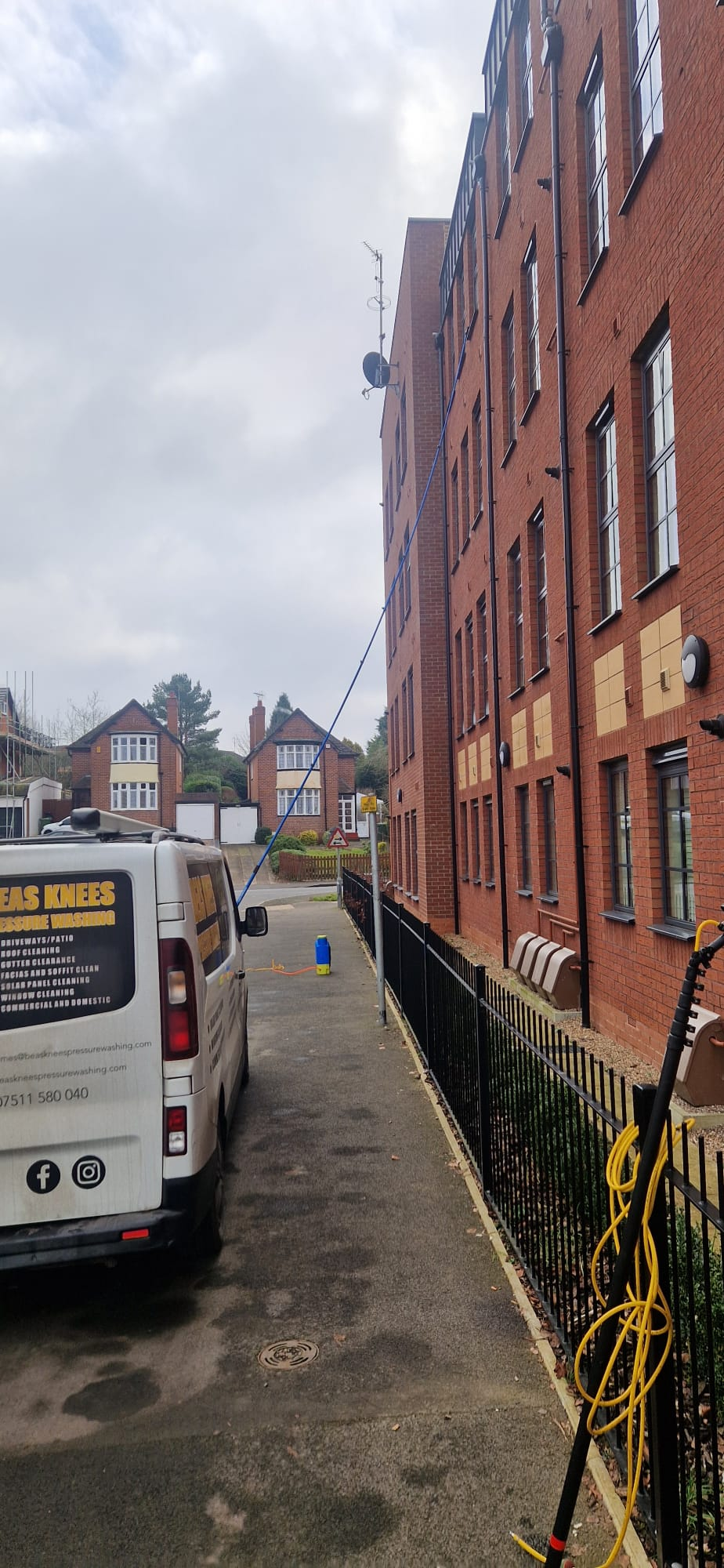 Beas Knees van and reach pole cleaning a commercial apartment building in Redditch, Worcestershire