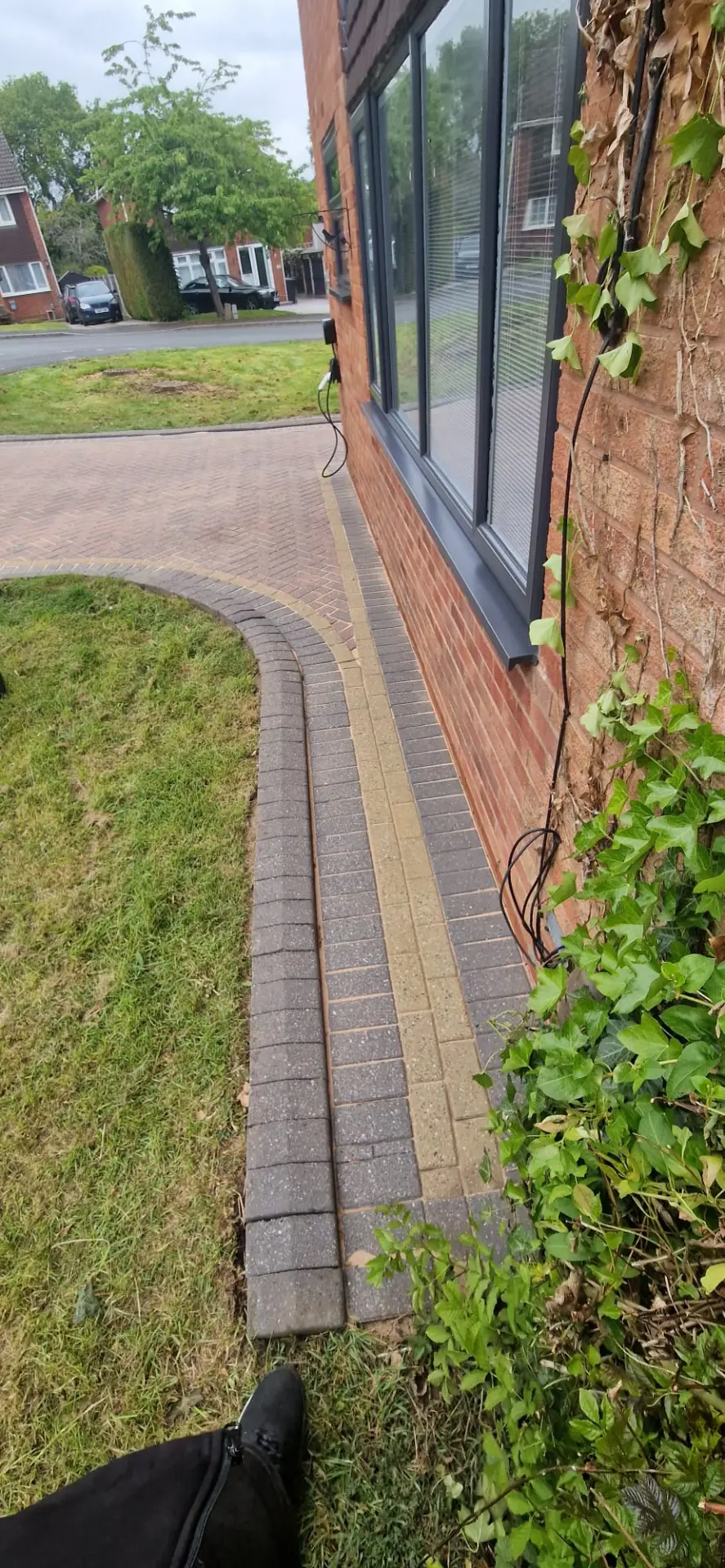 The same block paved path cleared of weeds and pressure washed back to clean brick paving