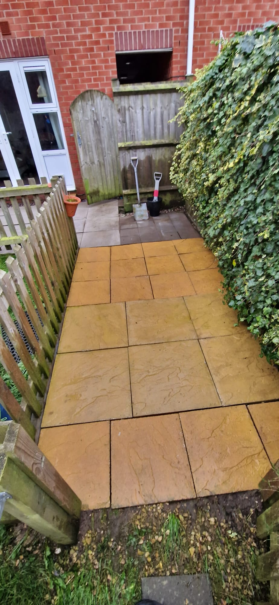 Sandstone patio slabs cleaned in a rear garden in Redditch, Worcestershire