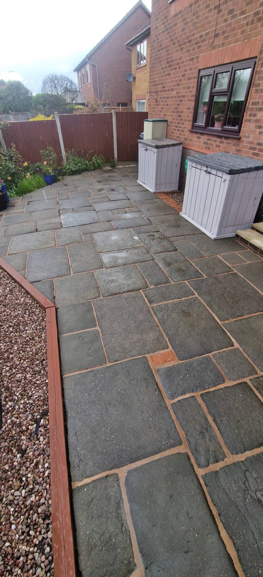 The same riven flagstone patio cleaned evenly across every flag