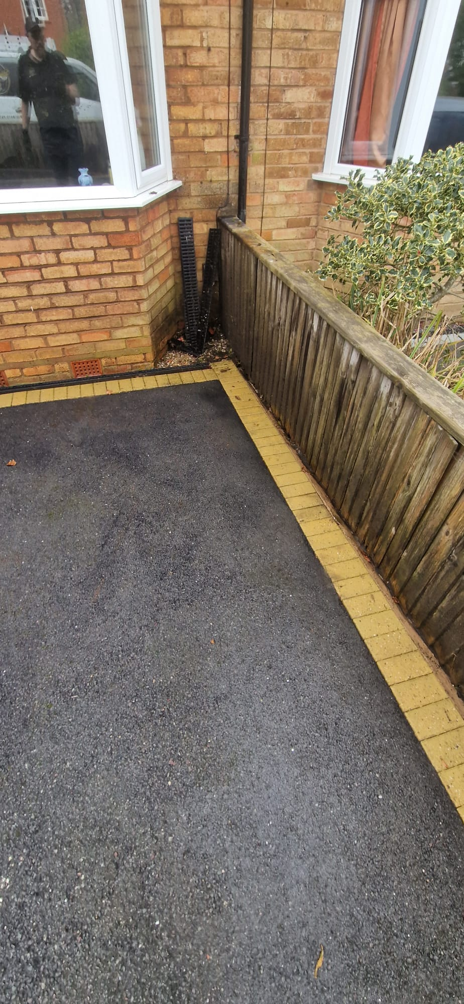 The same side path cleared and pressure washed back to clean tarmac and block edging